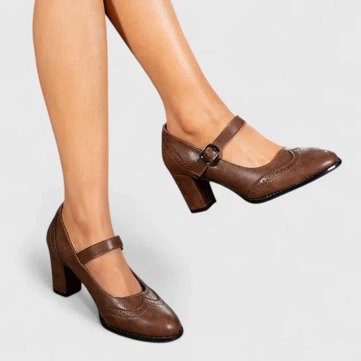 Brown leather Mary Jane block heel shoes with decorative stitching — side angle view on model