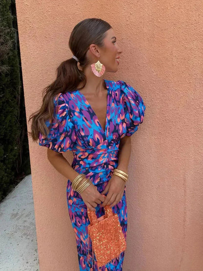 Colorful purple and blue printed maxi dress with puff sleeves and plunging neckline — side view