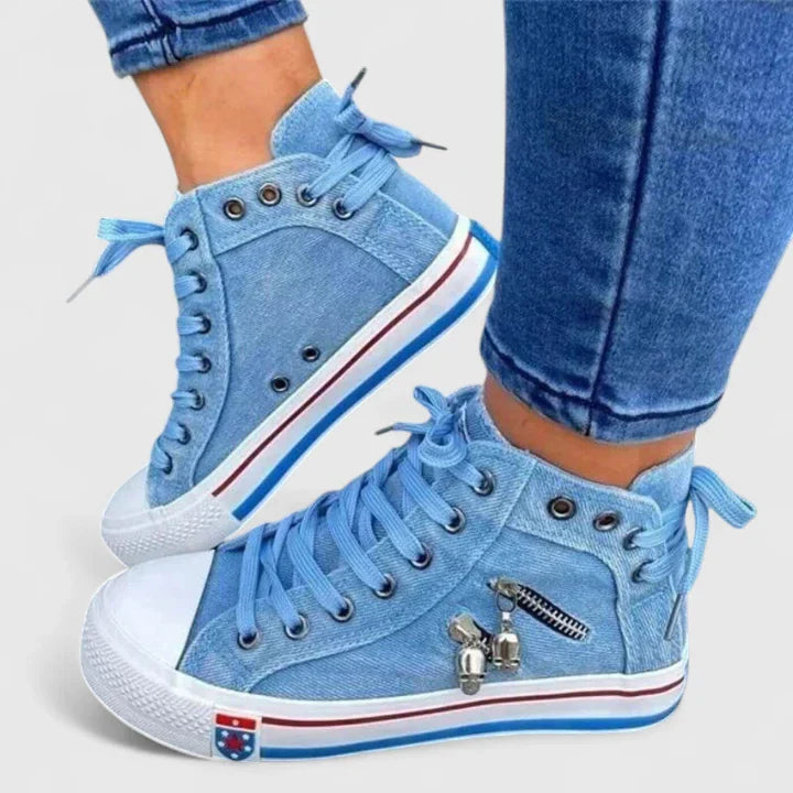 Light blue denim high-top sneakers with side zipper and lace-up closure — side view on model