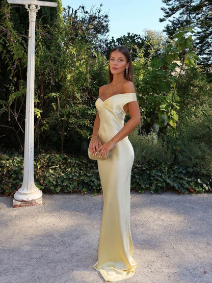 Pale yellow satin off-shoulder evening gown with draped bodice — front view