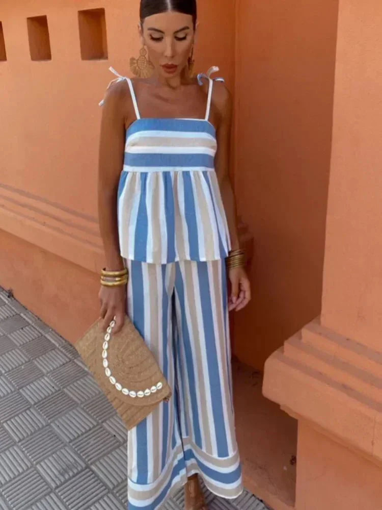 Women's blue and white striped midi dress with tie shoulder straps and flowy silhouette — front view