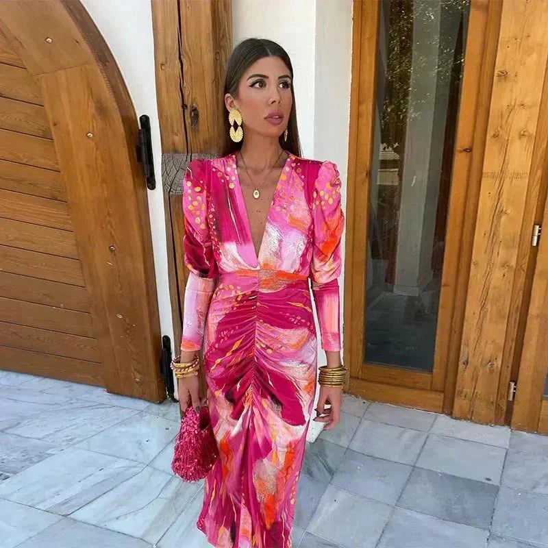 Pink floral wrap maxi dress with ruched detailing and long sleeves — front view