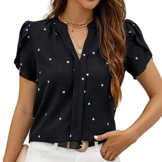 Black blouse with white heart print and puff sleeves — front view