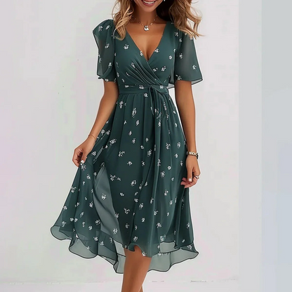Green floral midi dress with flutter sleeves and wrap waist tie — front view