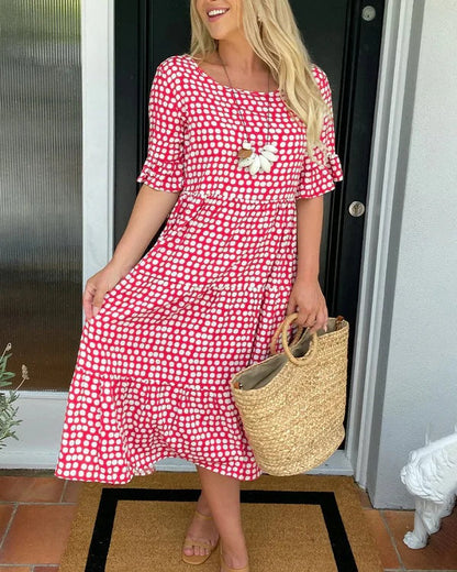Women's red and white polka dot midi dress with ruffle sleeves — front view on model