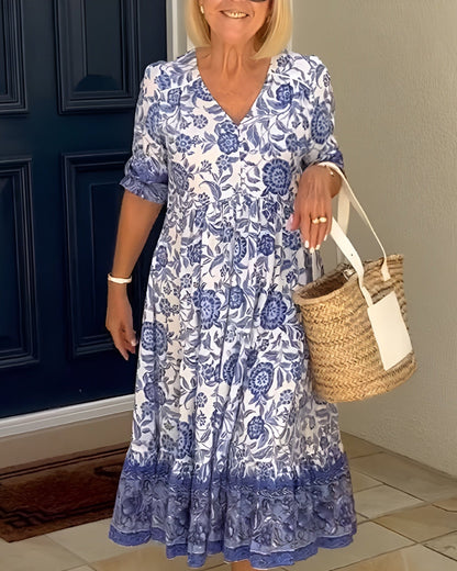 Floral print midi dress with blue and white pattern, tiered skirt, and short sleeves — front view