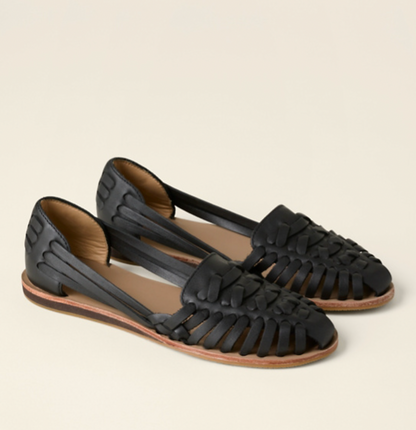 Black woven leather huarache sandals with tan insole — three-quarter front view