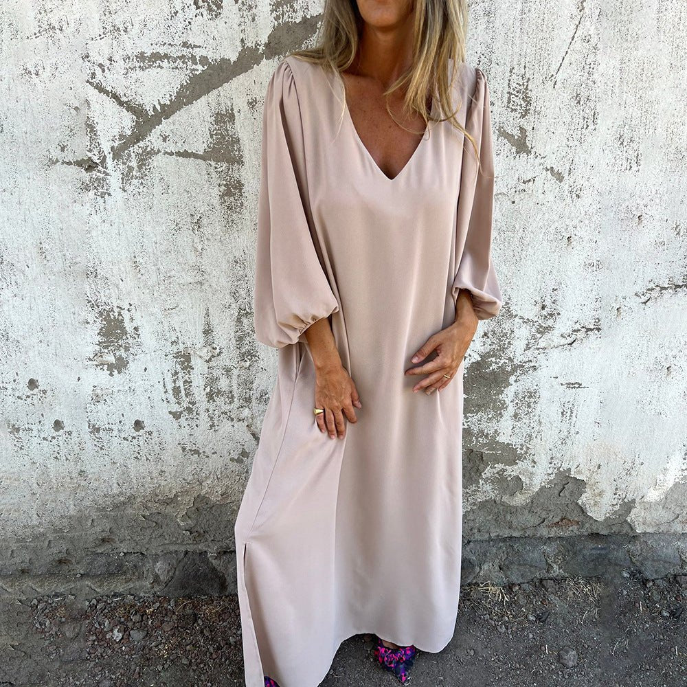 Beige flowing maxi dress with V-neck and balloon sleeves — front view