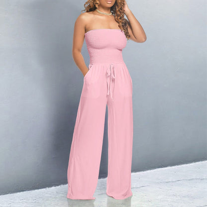 Pink strapless smocked jumpsuit with wide-leg pants and tie waist — front view