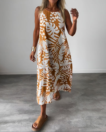 Sleeveless maxi dress with orange and white tropical leaf print — front view
