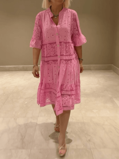 Pink eyelet lace midi dress with button front and ruffle sleeves — front view on model