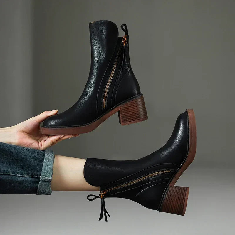 Black leather ankle boots with side zipper and wooden block heel — side and three-quarter view