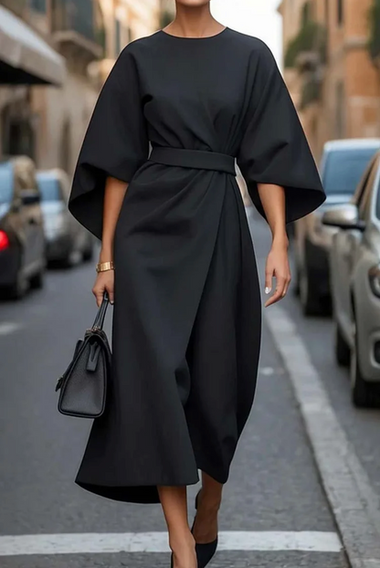 Black midi dress with dramatic lantern sleeves and wrap-style waist tie — front street view