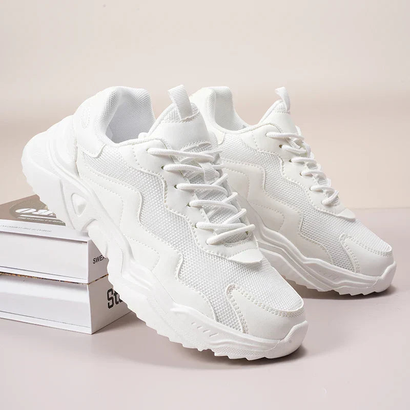 White chunky sole walking sneakers with mesh and leather upper — angled front view